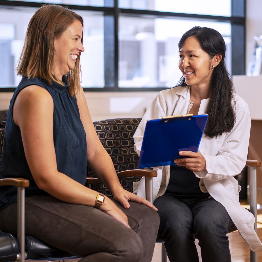 Woman meets with research staff to review information